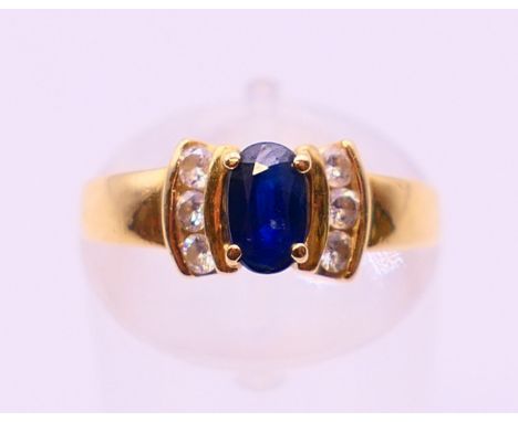 An 18 ct gold, sapphire and diamond ring. Ring size J/K.