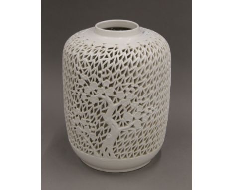 A Chinese white glazed lamp base with reticulated body decorated with cherry blossom tree. 32 cm high.