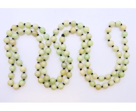 A jade necklace. 124 cm long.