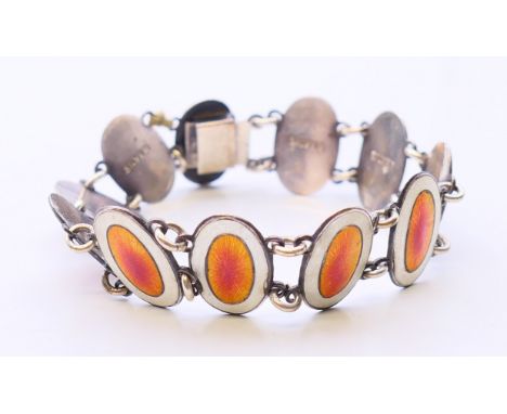 A silver and enamel bracelet. 18 cm long. 