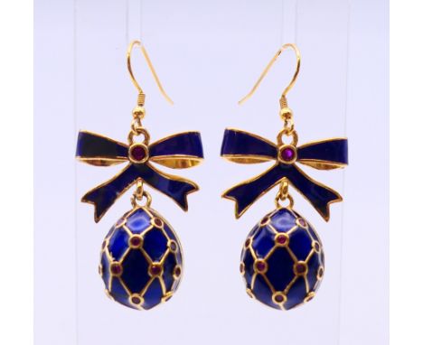 A pair of enamel egg and bow earrings, bearing Russian marks.  3 cm high excluding suspension loop.