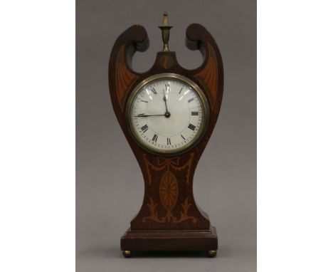 An Art Nouveau inlaid mahogany mantle clock. 29 cm high.