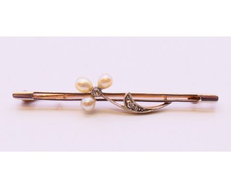 An unmarked gold, diamond and seed pearl bar brooch. 5 cm long. 