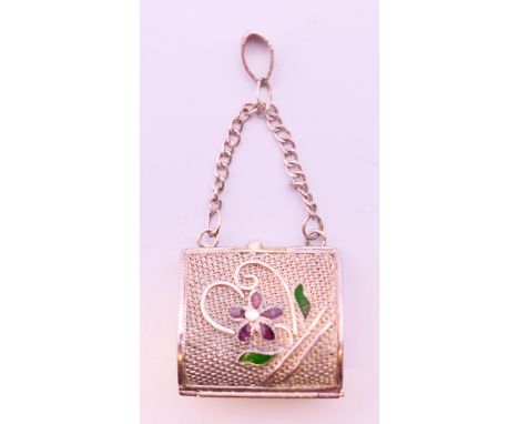 A silver filigree and enamel handbag form pendant.  2 cm wide.