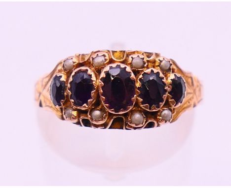 A 9 ct gold, garnet and seed pearl ring, hallmarked for Chester 1907?.  Ring size P.