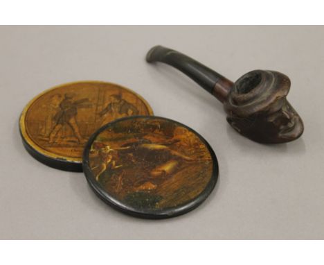 Two papier mache snuff box lids and a carved pipe. The latter 14.5 cm long.