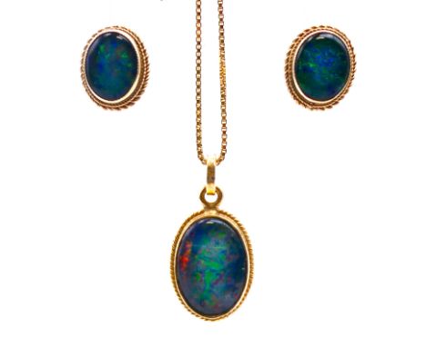An opal and gold pendant on an 18 ct gold chain and a pair of 9 ct gold matching earrings.  Pendant 2 cm high, chain 47 cm lo
