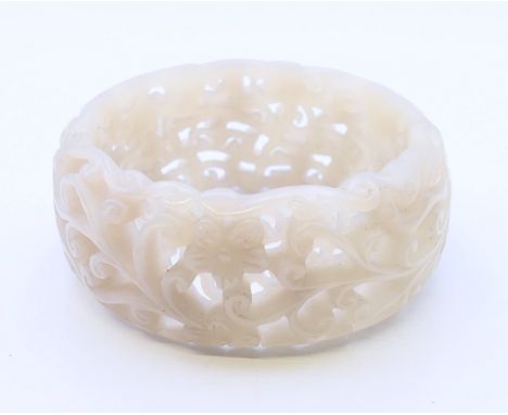A pierced celadon jade bangle.  6 cm inner diameter, 7.7 cm outer diameter, 3 cm high. 
