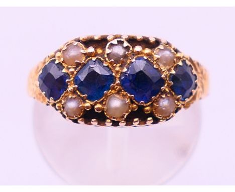 A 15 ct gold, sapphire and seed pearl ring, hallmarked for Birmingham.  Ring size J/K.