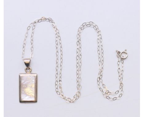 A silver and mother-of-pearl pendant on a silver chain.  Pendant 2 cm high, chain 50 cm high. 