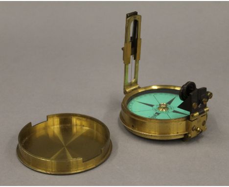 An Elliot Brothers brass compass in leather case. 7.75 cm diameter. 