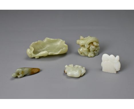 A GROUP OF CHINESE CARVED CELADON AND WHITE JADE ITEMS. To include a brush washer in the form of a lotus leaf with frog; A dr