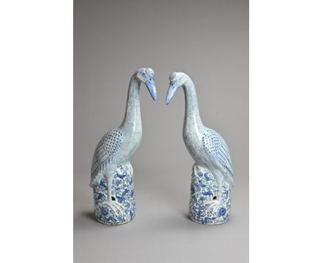A LARGE PAIR OF VINTAGE CHINESE BLUE AND WHITE PORCELAIN MODELS OF CRANES, 20TH CENTURY. Each on floral scroll bases. Approx.