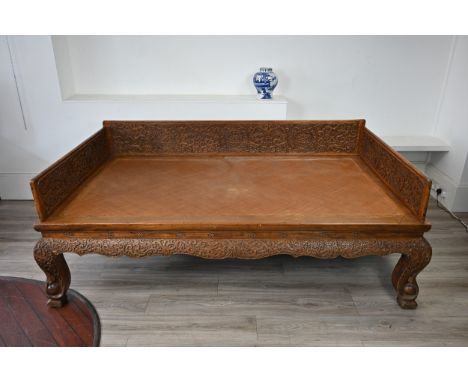 A LARGE CHINESE LUOHAN DAY BED CARVED IN THE MING STYLE WITH RATTAN BASE, QING DYNASTY. The removable gallery well-carved wit