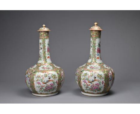 A LARGE PAIR OF CHINESE CANTON FAMILLE ROSE PORCELAIN BOTTLE VASES, 19TH CENTURY. Each with globular body leading into a tall