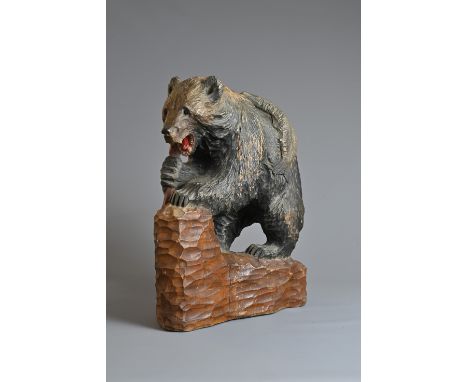 A LARGE 20TH CENTURY JAPANESE CARVED WOOD MODEL OF A HOKKAIDO BEAR. Naturalistically chip-carved and painted carrying a salmo