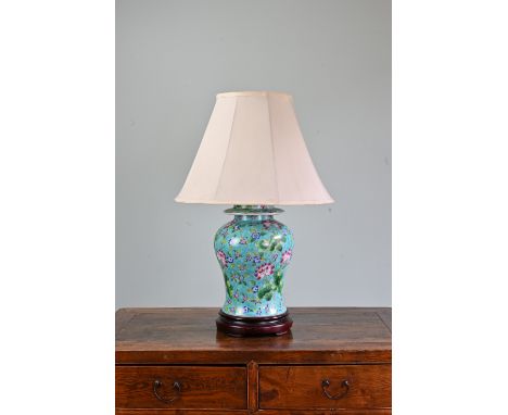 A CHINESE PORCELAIN VASE LAMP, 20TH CENTURY. The vase and cover turquoise ground with lotus flower decoration. Mounted on woo