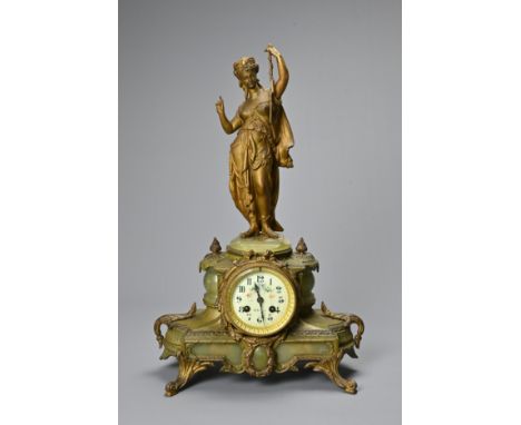 A LATE 19TH CENTURY FRENCH GILT-METAL AND ONYX MOUNTED FIGURAL MANTEL CLOCK. Surmounted with a gilt spelter figure of a drape