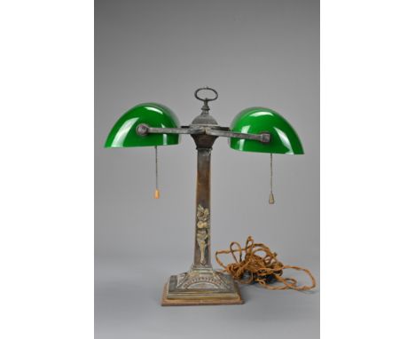 A MID-20TH CENTURY TWIN-LIGHT BANKER'S DESK-LAMP. With two adjustable green glass shades, on brass column base applied with f