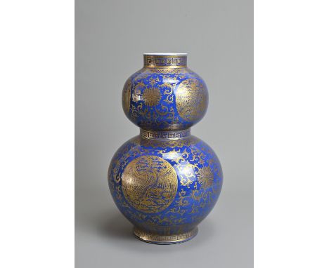 A CHINESE BLUE GROUND AND GILT DECORATED DOUBLE GOURD PORCELAIN VASE, 19/20TH CENTURY. Well decorated with various crane meda