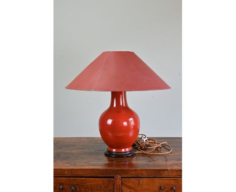 A CHINESE ORANGE GROUND PORCELAIN LAMP. The vase of baluster from covered in a reddish orange glaze. Mounted on wooden base w