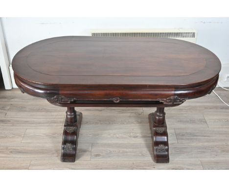 A CHINESE CARVED HARDWOOD TWIN-PEDESTAL DINING TABLE, CIRCA 1930S.  Of shaped rectangular form, with key pattern and scroll c