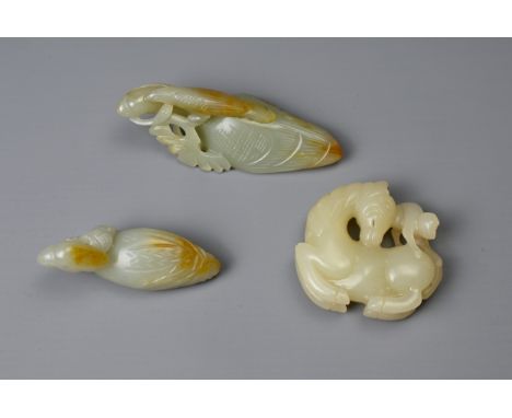 THREE CHINESE CARVED JADE ITEMS. Pale celadon carvings to include a bird group carving; A bird holding a lotus spray in its b