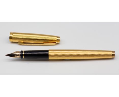 A Parker 585 engine turned fountain pen and cover, the nib stamped 14K (1)   Further details: minor wear commensurate with ag