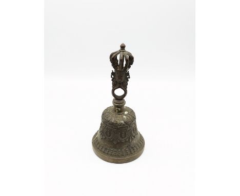 A Eastern 20th century cast brass bell with crown finial and masks to top, approx. 22cm high. Swag decoration to the body.