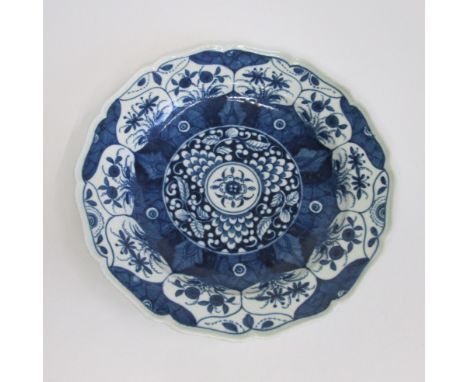 A Worcester plate, of lobed circular shape and painted in blue with the 'K'ang Hsi Lotus' pattern, unusual mark too the back,