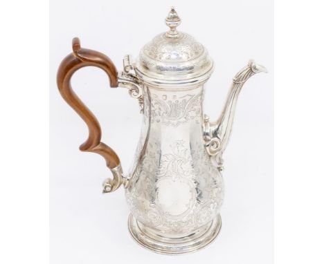 A George III silver coffee pot, baluster shaped engraved with scrolling foliage, the spout with rocaille terminals, S-scroll 