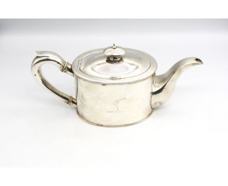 A George III silver teapot of oval shape with beaded borders, curved silver handle and silver finial, hallmarked by Andrew Fo