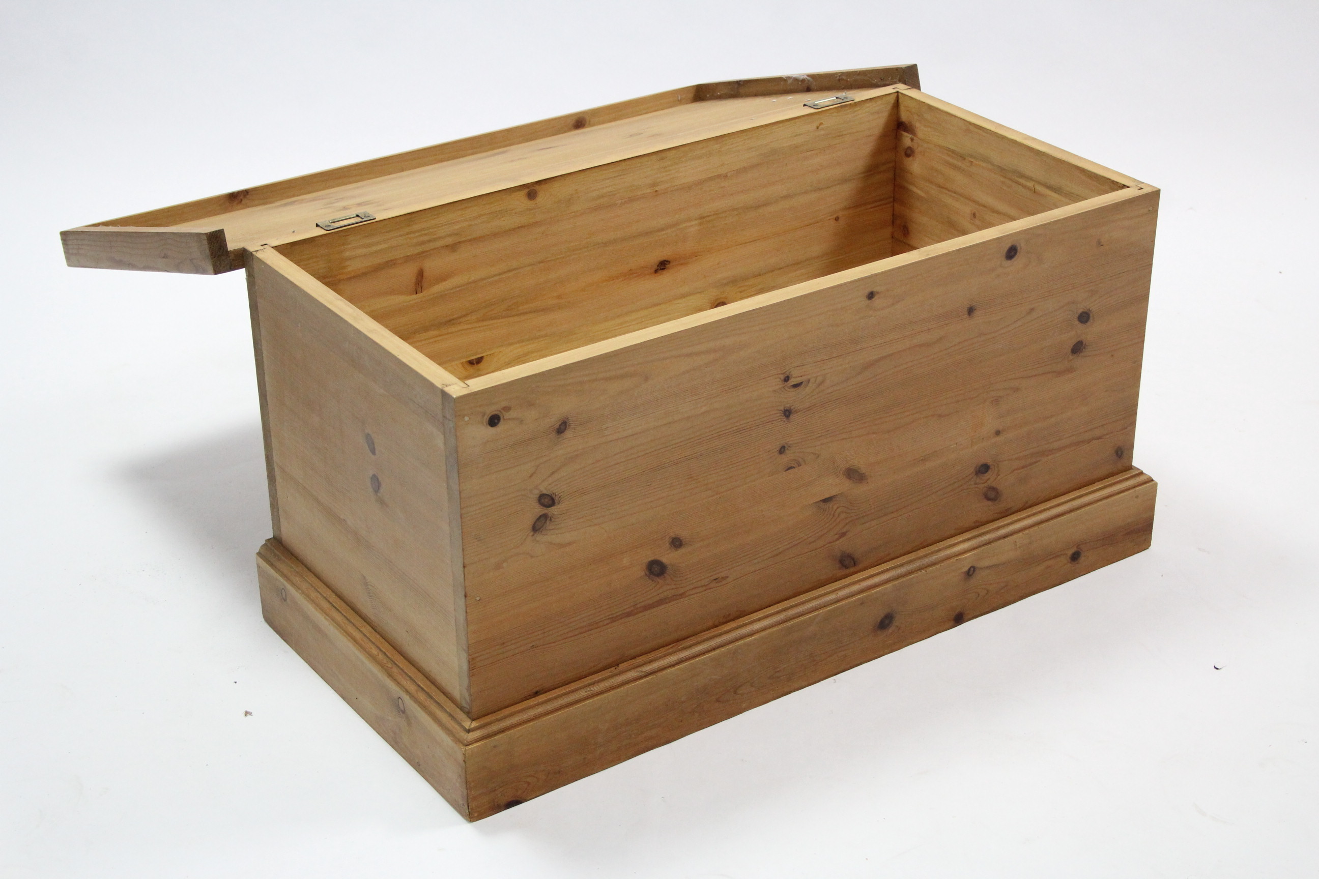 A pine blanket box with hinged liftlid, and on plinth base, 32¼" wide.