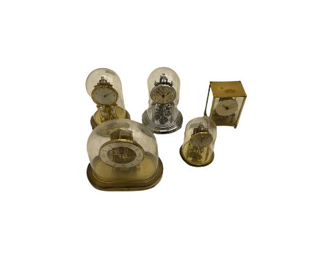 A  late 20th century German Kieninger & Obergfell, Kundo battery operated mantle clock under an acrylic shade, with four Germ