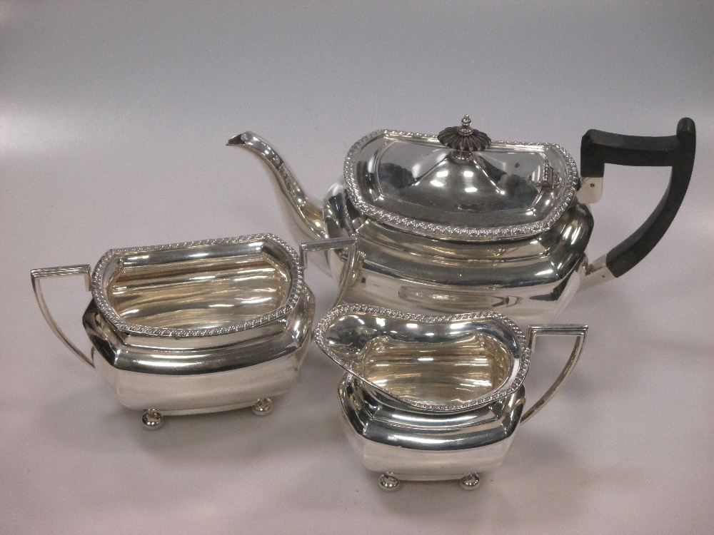 A silver three piece tea set by Walker and Hall, Sheffield 1931/1924