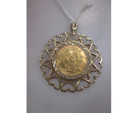 A 9ct gold pendant containing a George V half sovereign, 7.3g gross  