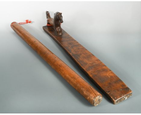 A Scandinavian birch mangling board and roller, probably early 19th century, the rectangular board mounted with a carved hors