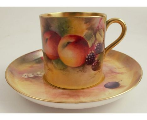 A Royal Worcester coffee can and saucer, painted to the exterior of the can and the saucer with fruit to a mossy background b