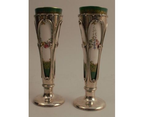 A pair of Royal Worcester and silver spill vases, the porcelain tapered vase decorated with flowers, in a hallmarked silver f