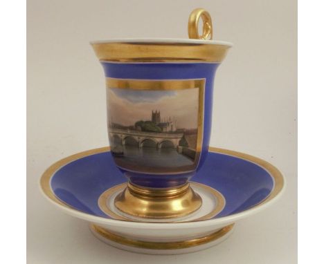 A 19th century French porcelain&nbsp;cup and saucer, with a blue ground reserving a painted panel of Worcester Cathedral and 