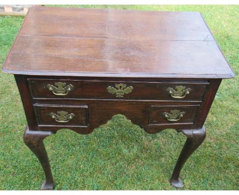 An Antique oak lowboy, fitted one long drawer and two short drawers, raised on cabriole legs and pad feet, 29ins x 18ins, hei