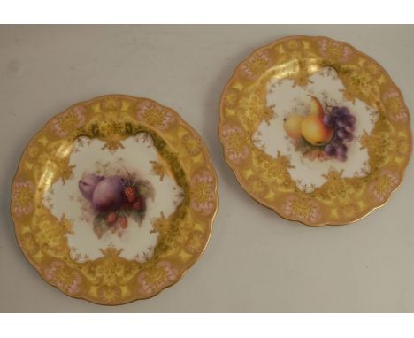 A pair of Royal Worcester plates, decorated with central panels of fruit to a yellow and git border, by Richard Seabright,&nb