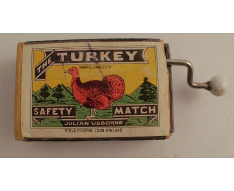 A Japanese wind up musical mechanism, playing jingle bells, in a The Turkey Safety Matches box