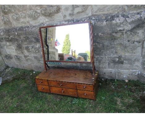A large 19th century mahogany swing frame toilet mirror, the base fitted with two long central drawers, flanked by two short 
