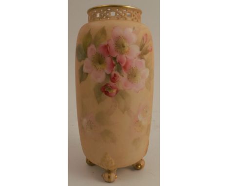 A Grainger &amp; Co Worcester blush ivory cylindrical vase, with pierced neck, decorated with pink blossom, raised on four kn