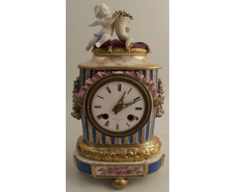 A porcelain mantel clock, the drum movement stamped Dixon &amp; Co Paris, with enamel dial, the porcelain case mounted with a