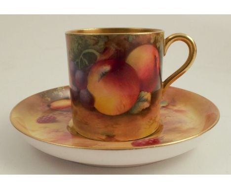 A Royal Worcester coffee can and saucer, painted to the exterior of the can and the saucer with fruit to a mossy background b