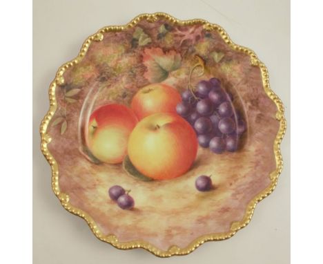 A Royal Worcester plate, decorated with hand painted fruit by H Ayrton, to a shaped gilt edge, dated 1949, diameter 8.75ins g
