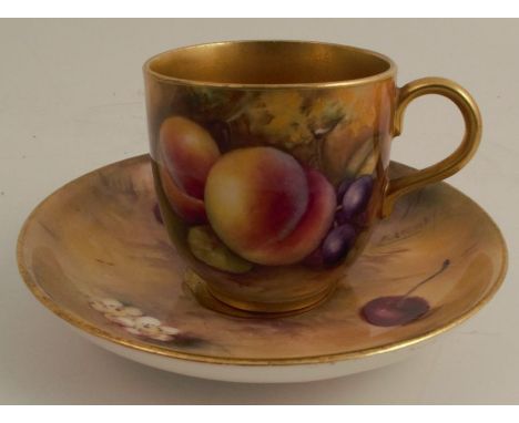 A Royal Worcester cabinet cup and saucer, the exterior of the cup and the saucer decorated with fruit to a mossy background b