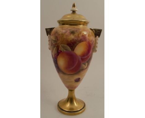 A Royal Worcester covered pedestal vase, decorated all around with fruit to a mossy background by Skerrett, with gilded cover